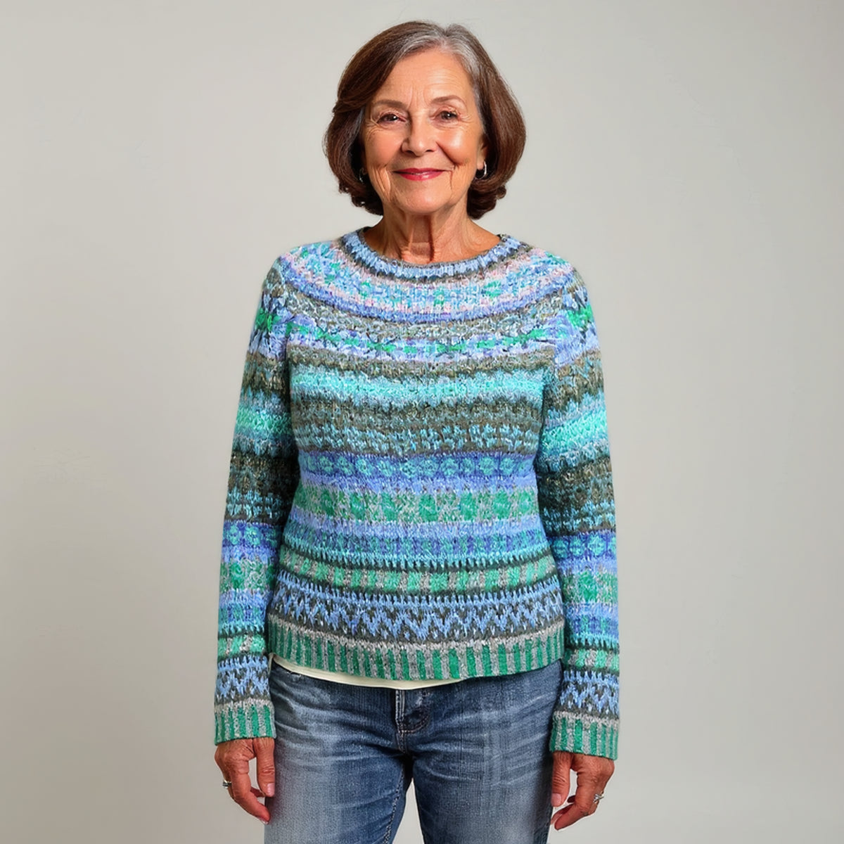 Pull bleu et vert à motifs géométriques